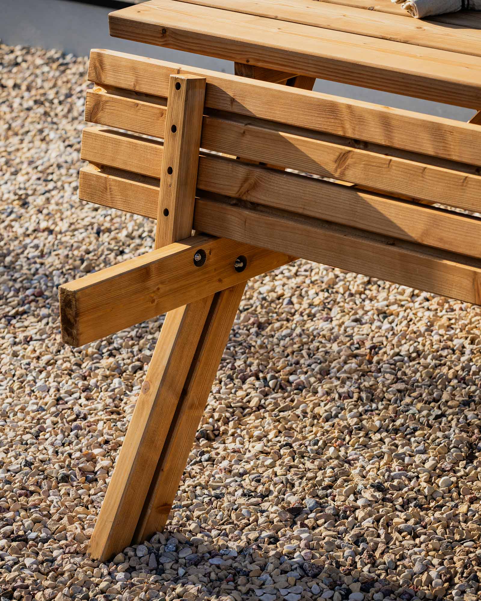Closeup of the fastenings for a brown garden picnic table