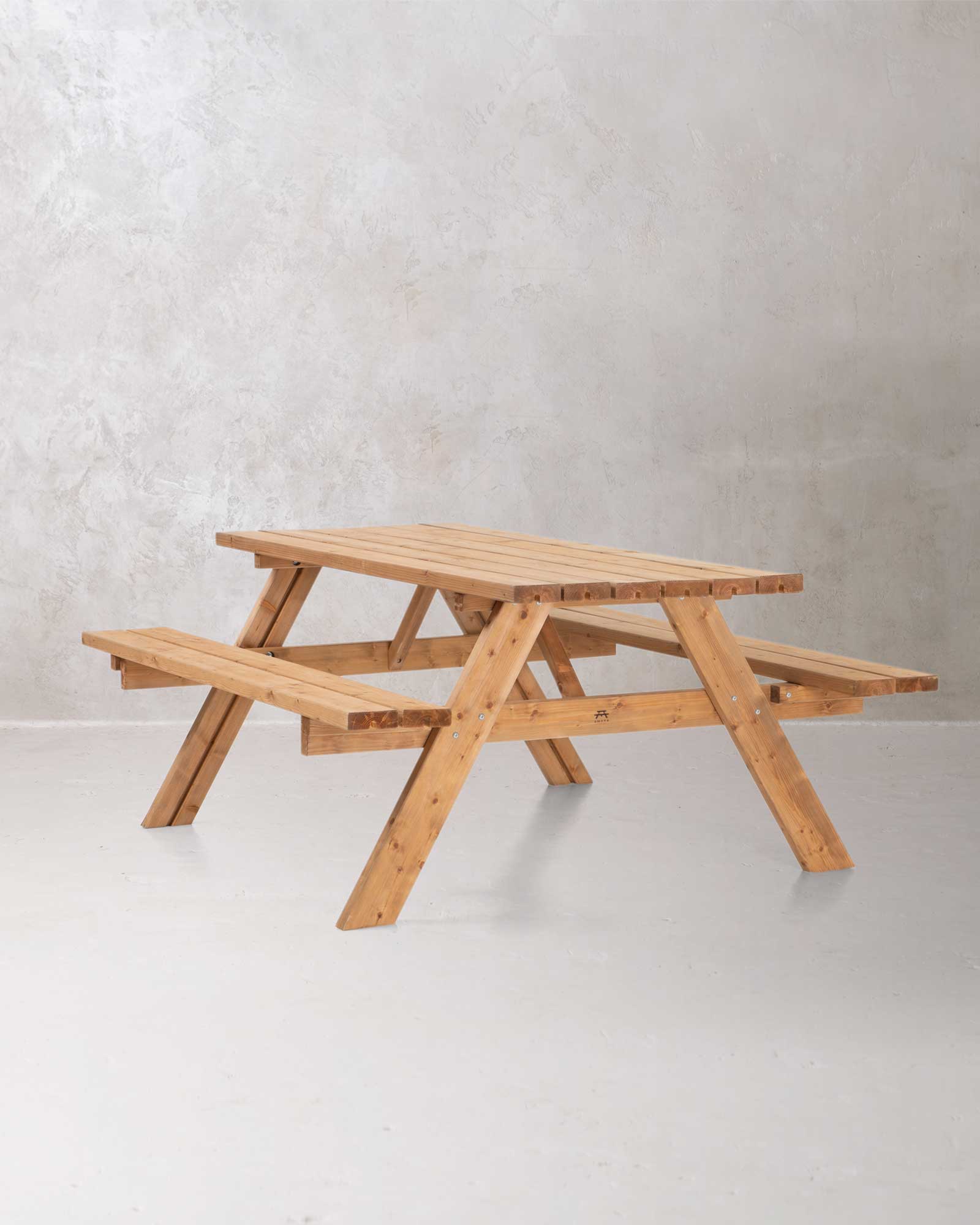Brown wooden picnic table on a concrete background at a 45 degree angle