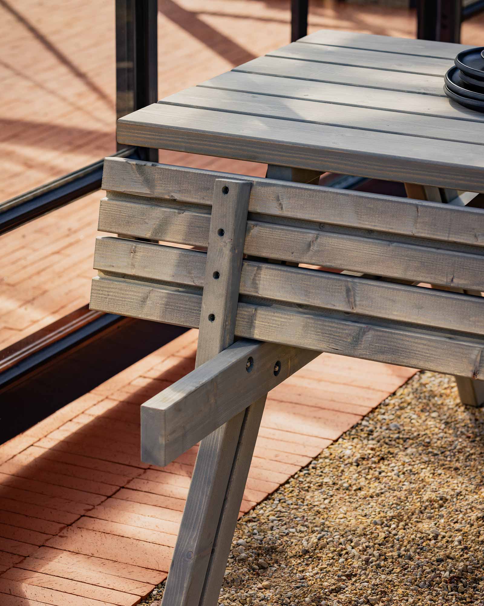 Closeup of a grey picnic table and chair set