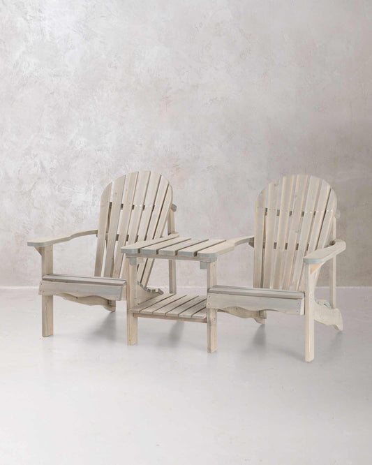 Double grey wooden Adirondack chair set on a concrete background, photographed at a slight angle