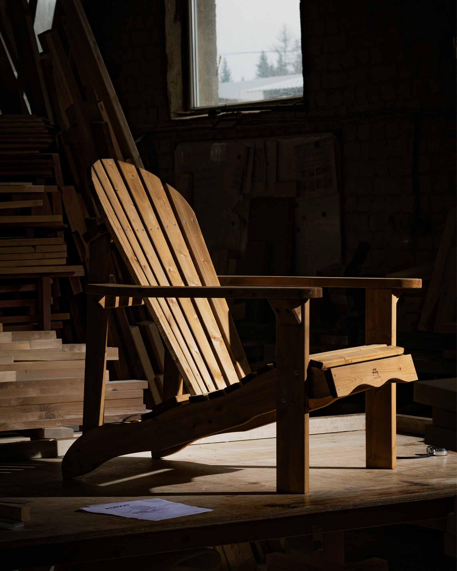 Brown wooden Adirondack chair in a workshop