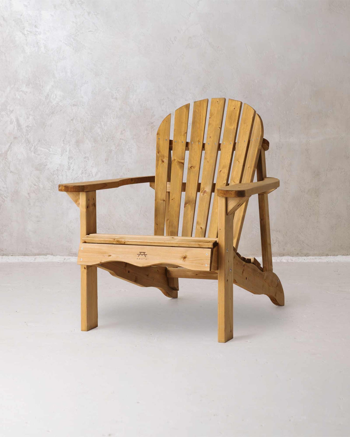 Brown wooden Adirondack chair on a concrete background, photographed from the front and at a slight angle