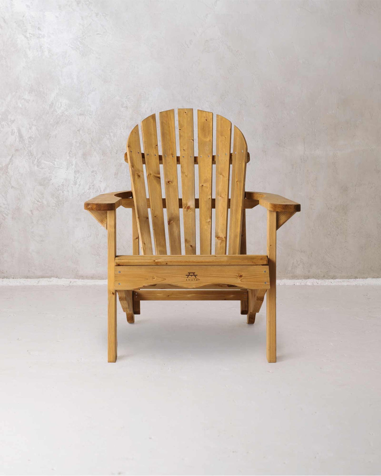 Brown wooden Adirondack chair on a concrete background, photographed from the front