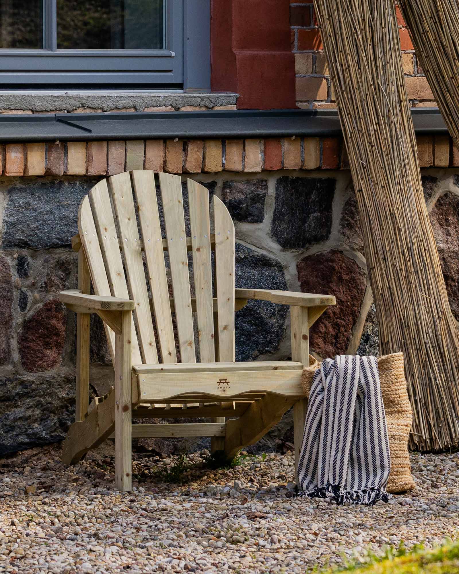 Green Adirondack chair next to a large stone house