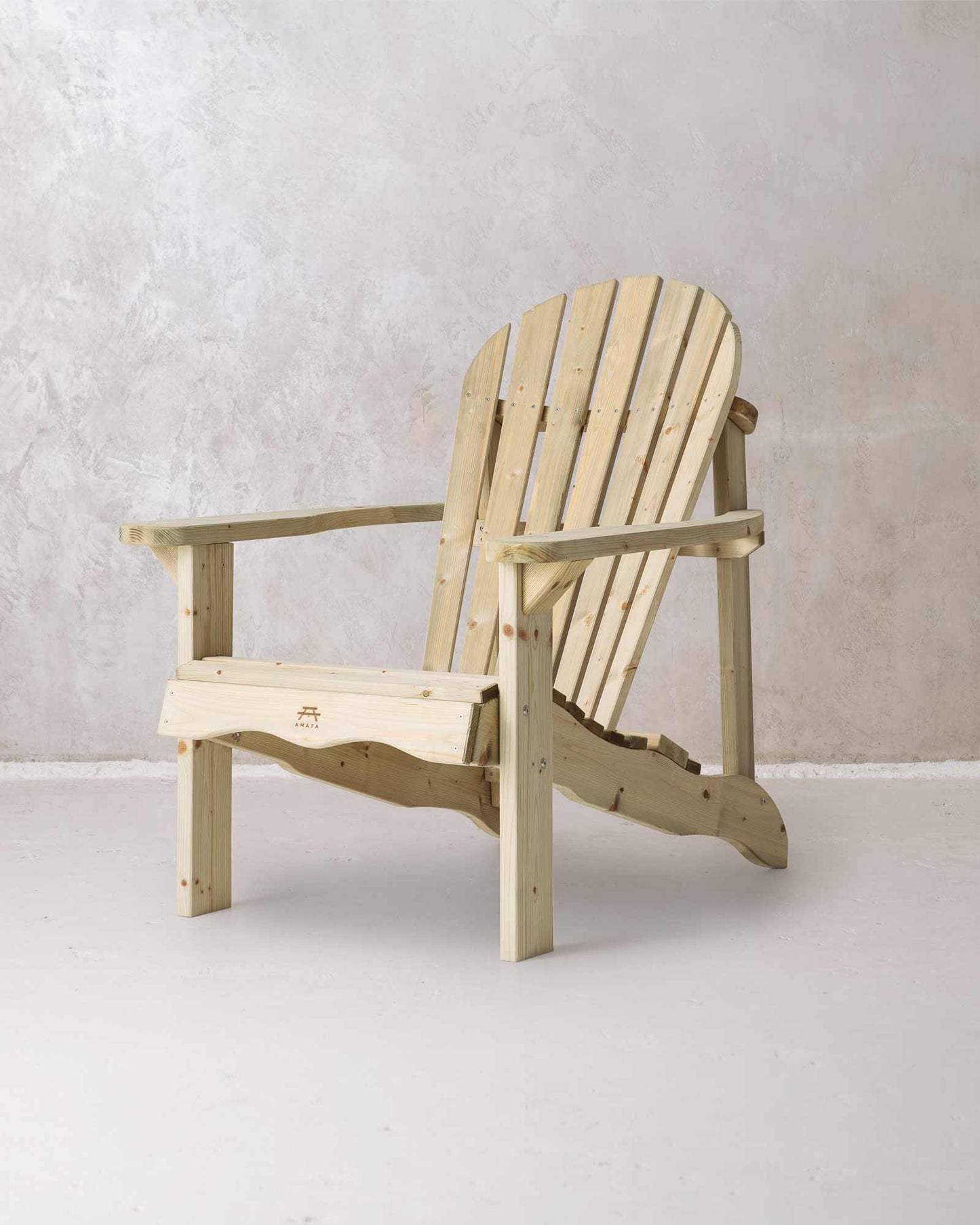Green wooden Adirondack chair on a concrete background, photographed from a slight angle