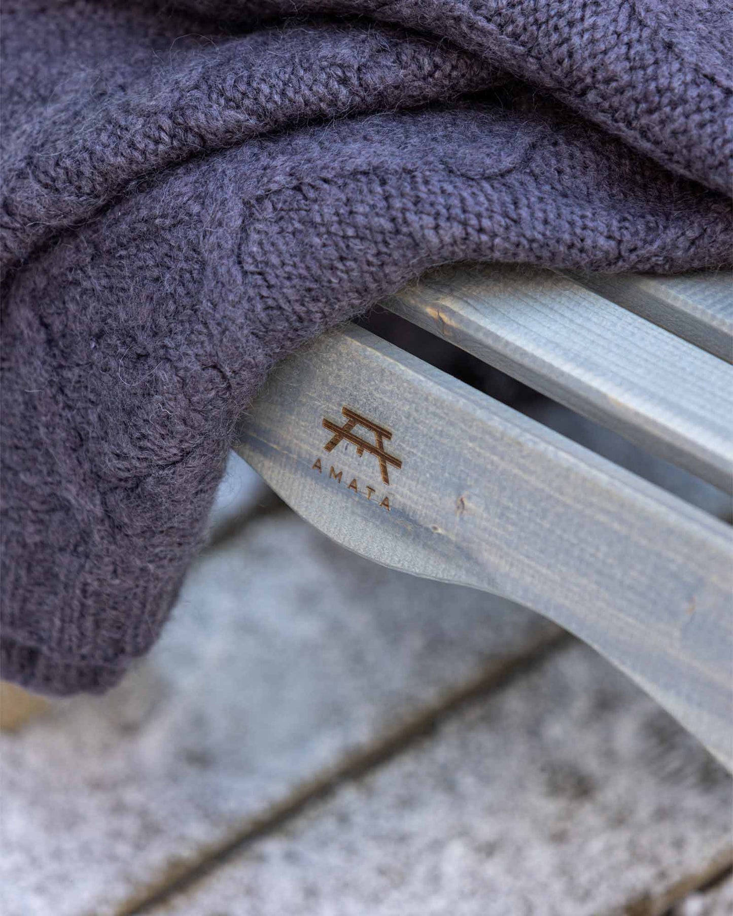 Closeup of the AMATA logo burnt on the chair