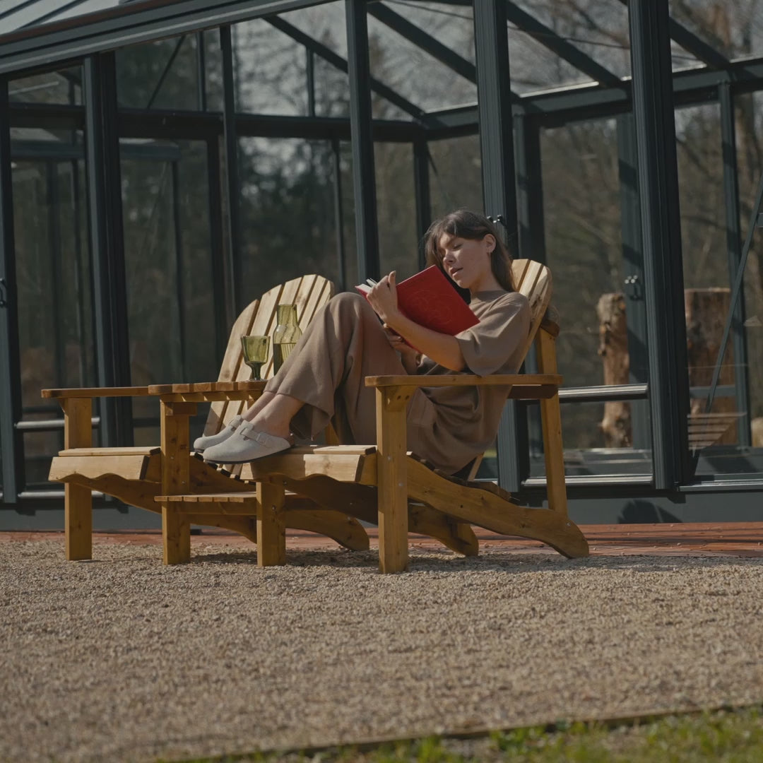 Girl reading a book while sitting in a double Adirondack garden chair