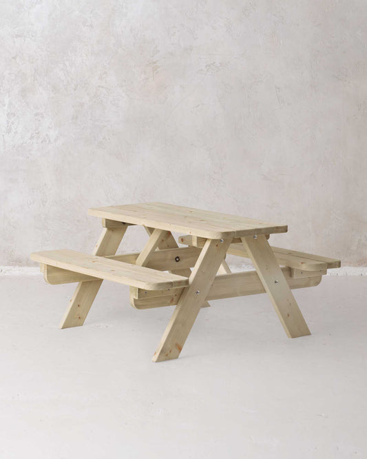 Mini picnic table in green wood on a concrete background, slightly angled